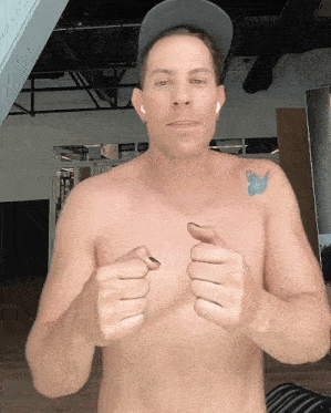 a shirtless man with a butterfly tattoo on his shoulder