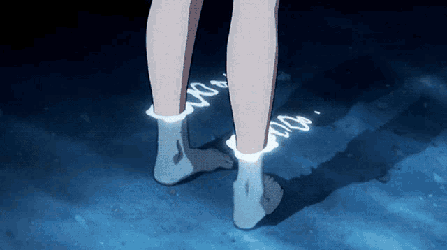 a person 's feet are glowing in the dark and their socks are glowing