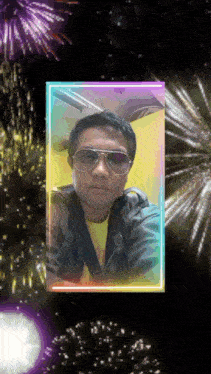 a man wearing sunglasses is surrounded by fireworks in a neon frame