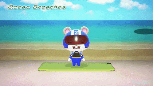 a bear wearing a helmet with the number 21 on it stands on a yoga mat on the beach