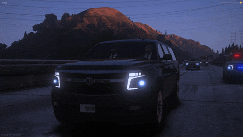 a black suv with a license plate that says 9gdjp is driving down a highway at night