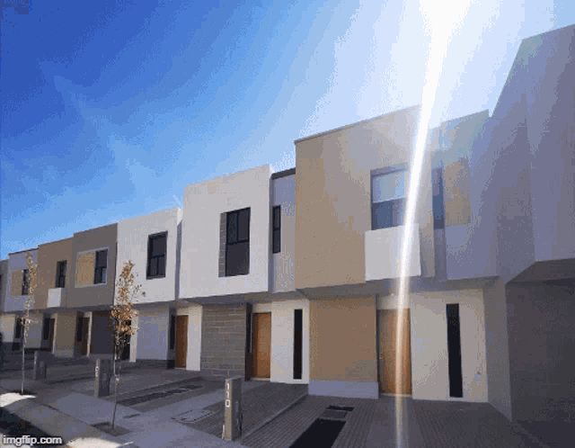 a row of houses with the sun shining through them
