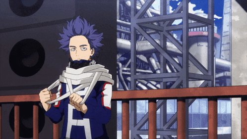 a man with purple hair and a shirt that says h