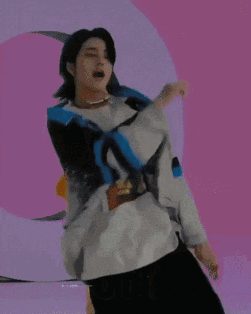 a man is dancing in front of a sign that says ' i love you ' on it .