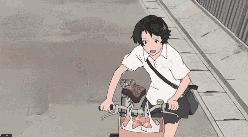 a girl is riding a bike down a sidewalk with a starfish in the basket .