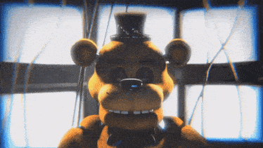 a yellow teddy bear with a top hat on