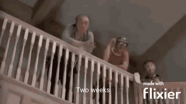 a group of people standing on a balcony with the words two weeks made with flixier .