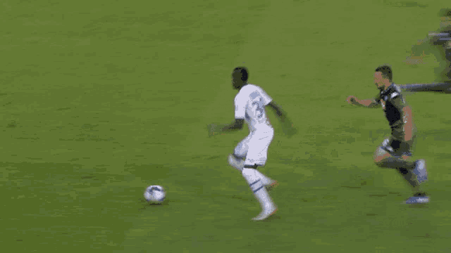 a soccer player with the number 18 on his jersey is kicking the ball