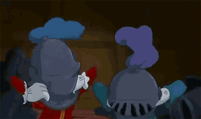 mickey mouse and minnie mouse are standing next to each other in a room .