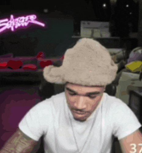 a man wearing a white shirt and a furry hat has the number 37 on his arm