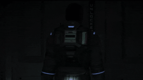 a man is standing in a dark room with a sign that says emergency on it