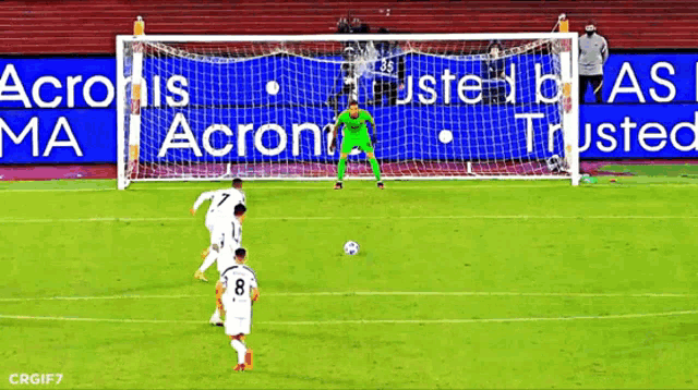 a soccer game is being played in front of an acronis ma ad