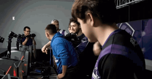 a group of people are standing in a room with a sign that says n