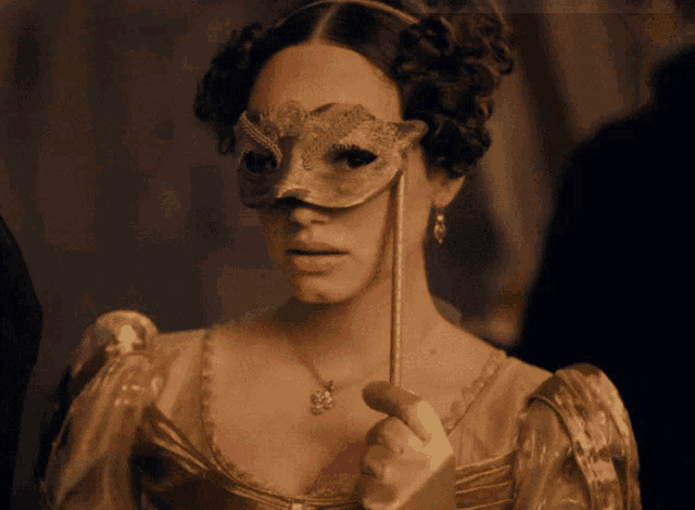 a woman wearing a mask and holding a wand