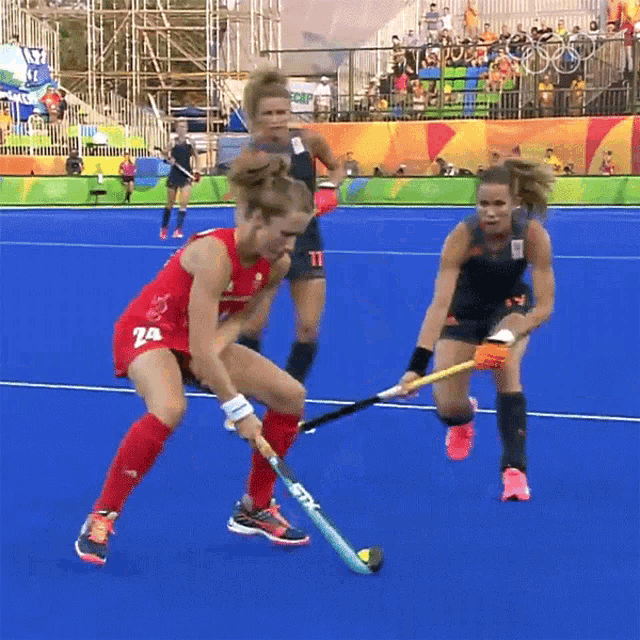 a field hockey player wearing a red uniform with the number 74 on it
