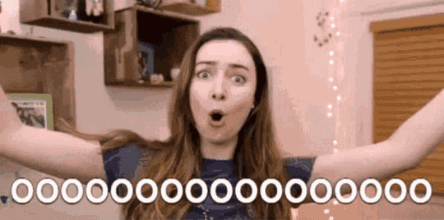a woman with a surprised look on her face is holding her arms in the air and says 000000 ..