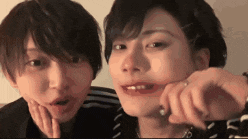 two young men are making funny faces for a picture .