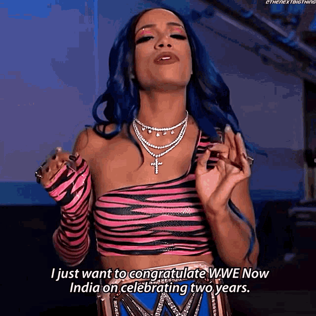 a woman with blue hair says " i just want to congratulate wwe now india on celebrating two years .. "