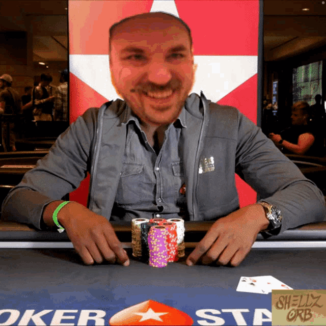 a man sits at a poker table with chips and a sign that says shelly orb