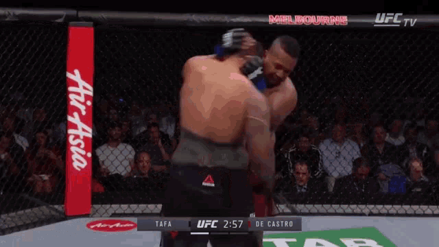 two men are fighting in a ufc cage and the ufc tv says melbourne