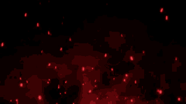 a bunch of red sparks are flying in the dark