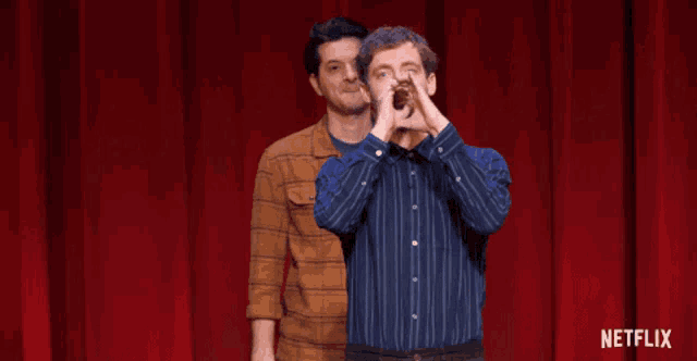 two men on a stage with netflix written on the bottom right