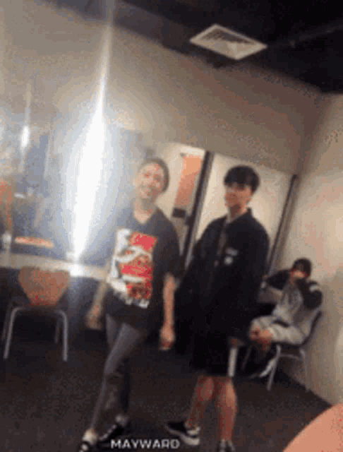 a group of people are standing in a room with mayward written on the bottom