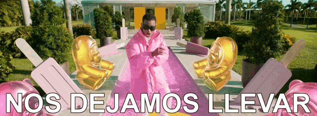 a man in a pink coat is surrounded by balloons and says nos dejamos llevar
