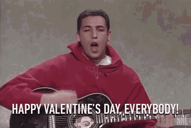 a man in a red hoodie is playing a guitar and singing happy valentine 's day everybody !