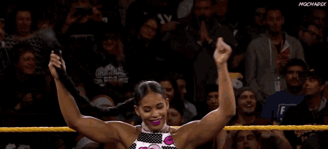 a woman in a wrestling ring is wearing a top that says ' original ' on it