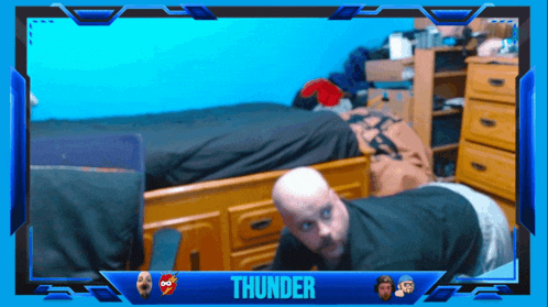 a man is doing push ups in front of a blue frame that says thunder on it