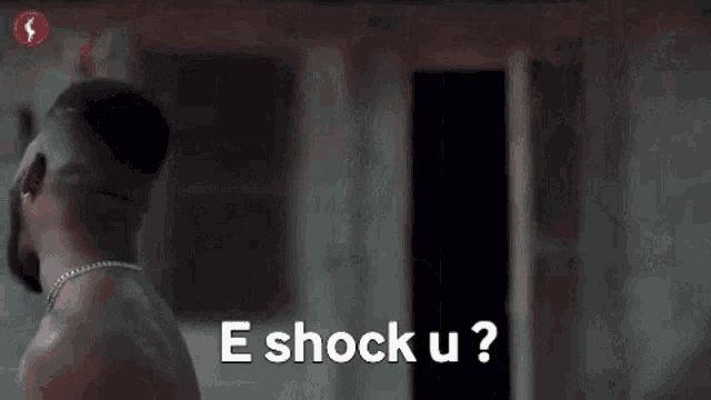 a shirtless man with a beard is screaming in a dark room .