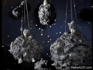a group of rocks hanging from ropes in space with makeagif.com in the corner
