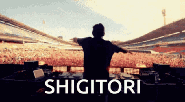 a man is standing in front of a crowd with the word shigitori on the bottom right