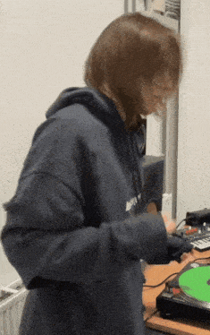 a woman wearing a hoodie that says ' a & m ' on it