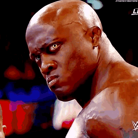 a close up of a man 's face with a w logo on his shoulder