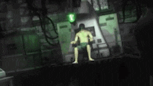 a naked man is sitting in a chair in a dark room .