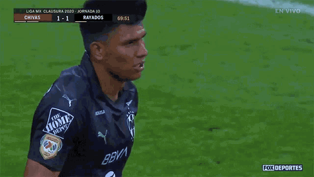 a soccer player wearing a black shirt that says the home depot on it
