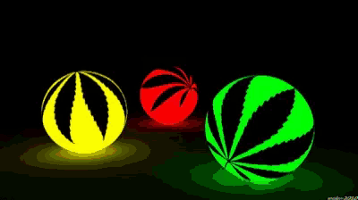 three balls with leaves on them are lit up in different colors