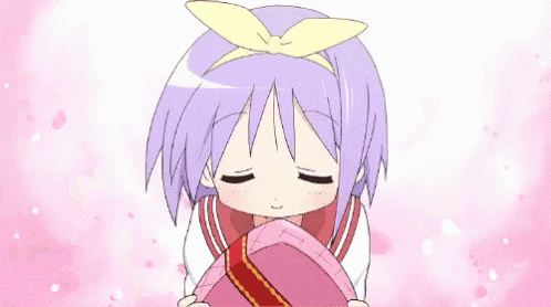 a little girl with purple hair is holding a pink heart shaped box