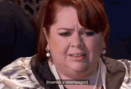 a close up of a woman 's face with the words [ truenos y relampagos ] visible