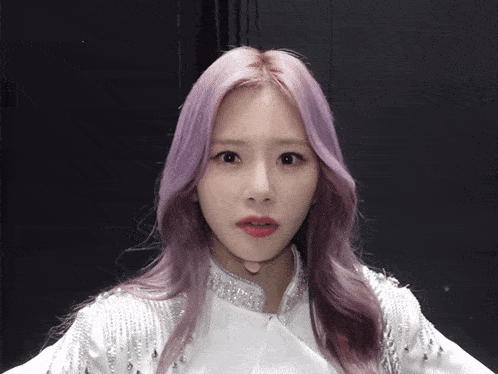 a girl with purple hair is wearing a choker
