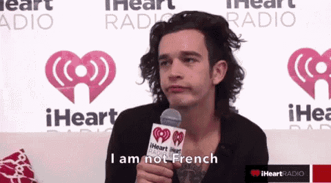 a man is holding a microphone and says i am not french on it
