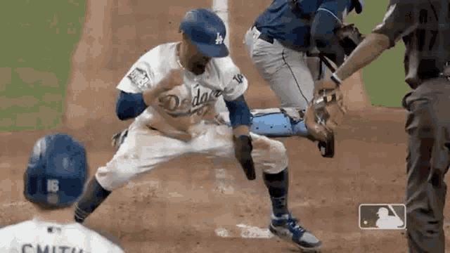 a baseball player in a dodgers uniform is sliding into base