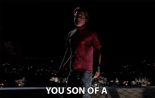 a man in a red shirt says " you son of a " in the dark