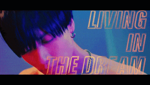 a close up of a person 's face with the words living in the dream behind him