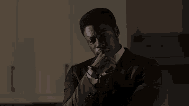 a man in a suit and tie with his arms crossed