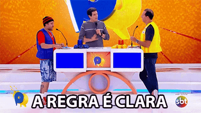 three men standing around a table with a sign that says a regra e clara on it