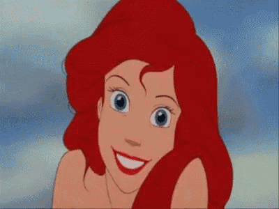 a close up of a cartoon character with red hair .