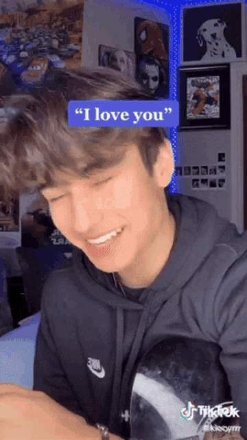 a young man says " i love you " while wearing a nike sweatshirt